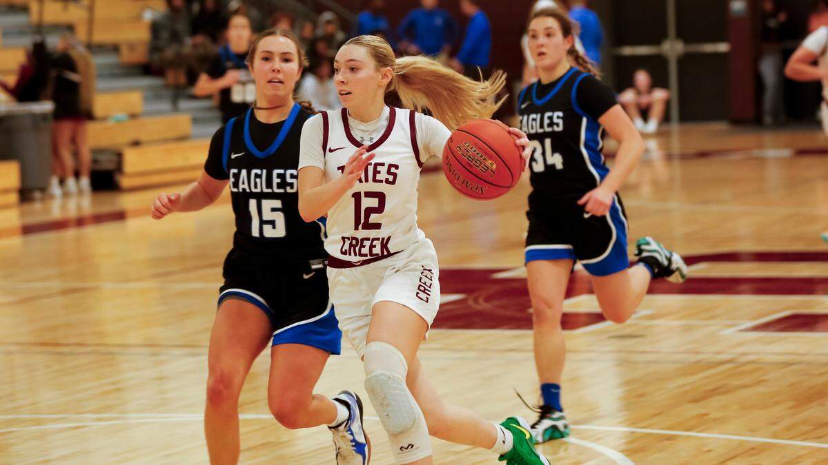 Tates Creek’s Kaleigh Potts (12) leads a fast break with Lexington Christian’s Chapel Brown (15) and Jentry Bertram (34) trailing the play during their game at Tates Creek High School on Tuesday.