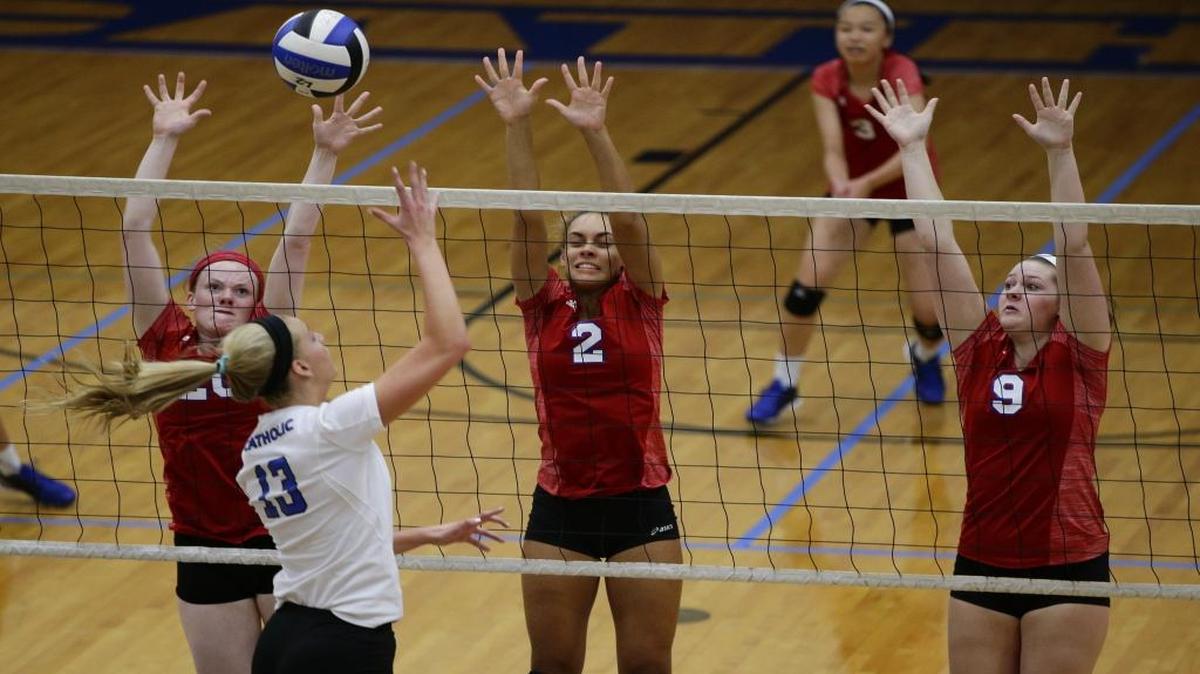 Lafayette's Alyssa Jones, 20, Lexi Lawson, 2, and Ella Reed, 9, combine to defend the shot of Lexington Catholic's Julia Hatcher ,23, as Lafayette defeats Lexington Catholic in four games on Thursday September 8, 2016 in Lexington, Ky.