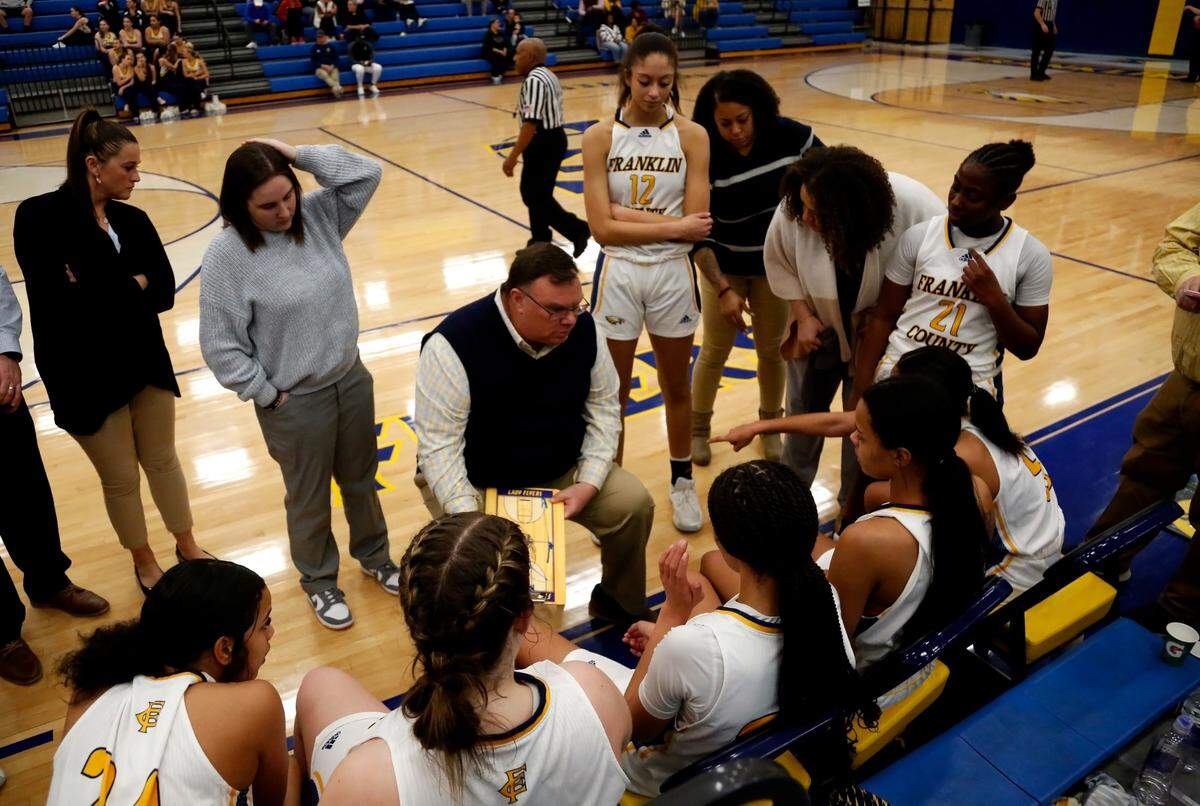 Franklin County coach Joey Thacker instructs his team during a fourth-quarter timeout of the Flyers’ 66-46 win over Ryle in Frankfort on Feb. 15.