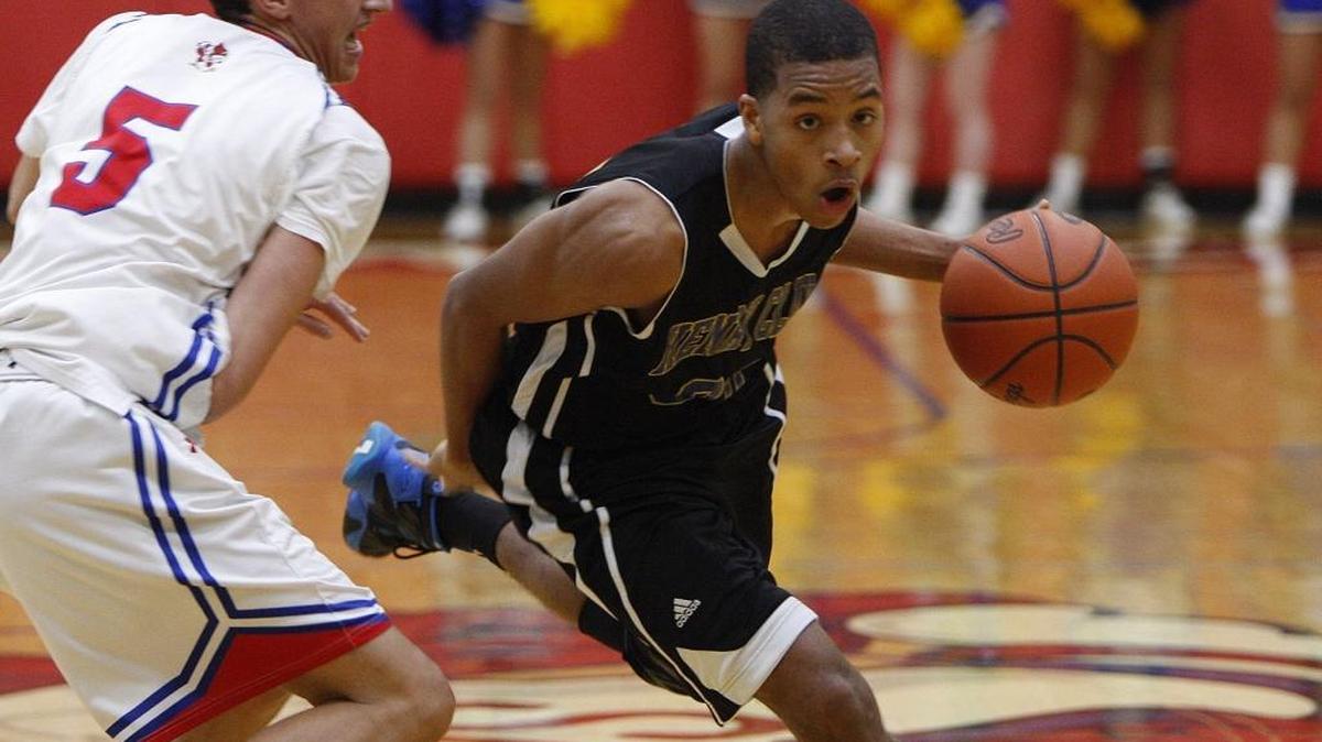 Henry Clay's Isaiah Tisdale dribbles against the pressure by Scott County's Dakoda Allen, left, as the Blue Devils won the 42nd district basketball tournament at Scott Co. High School gymnasium in Georgetown, Ky., Thursday, February 25, 2016.