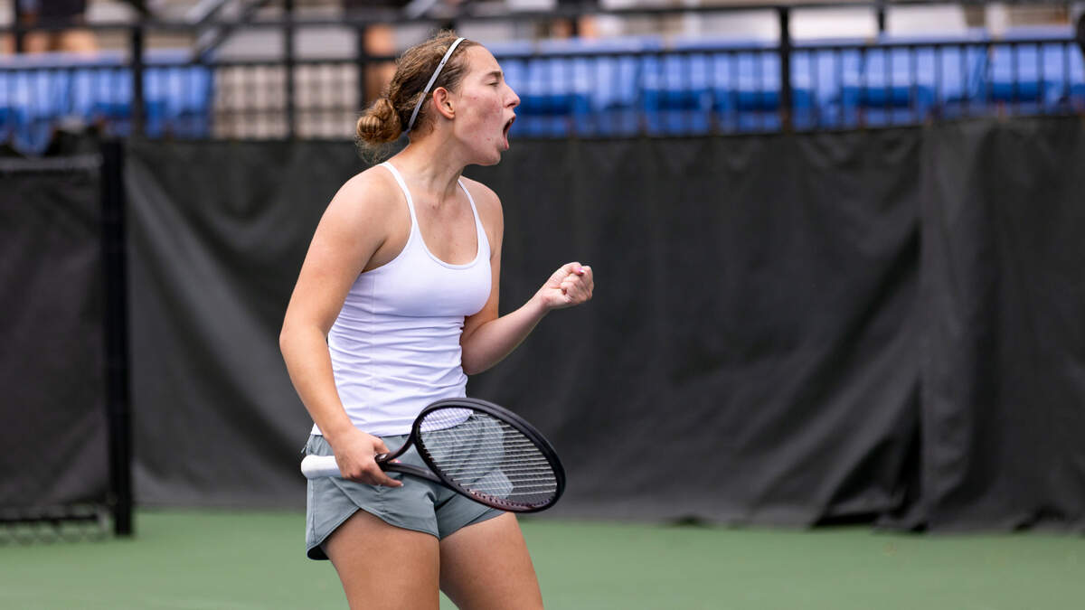 Scott County’s Sydney Zakic celebrates winning the first set against Sacred Heart’s Claire Rueff on Thursday.