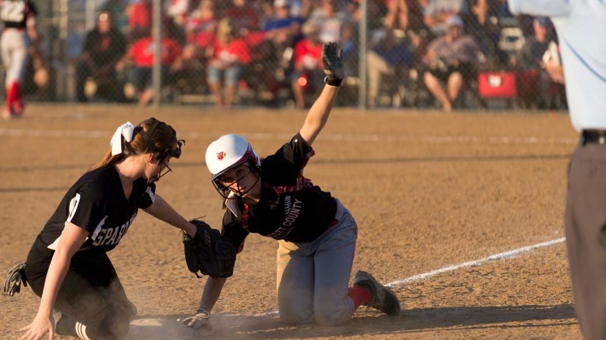 Scott County outfielder Emily Jasper slides back to third base during the second inning of the game against South Warren in the first round game on Thursday at Jack C. Fisher Park in Owensboro.