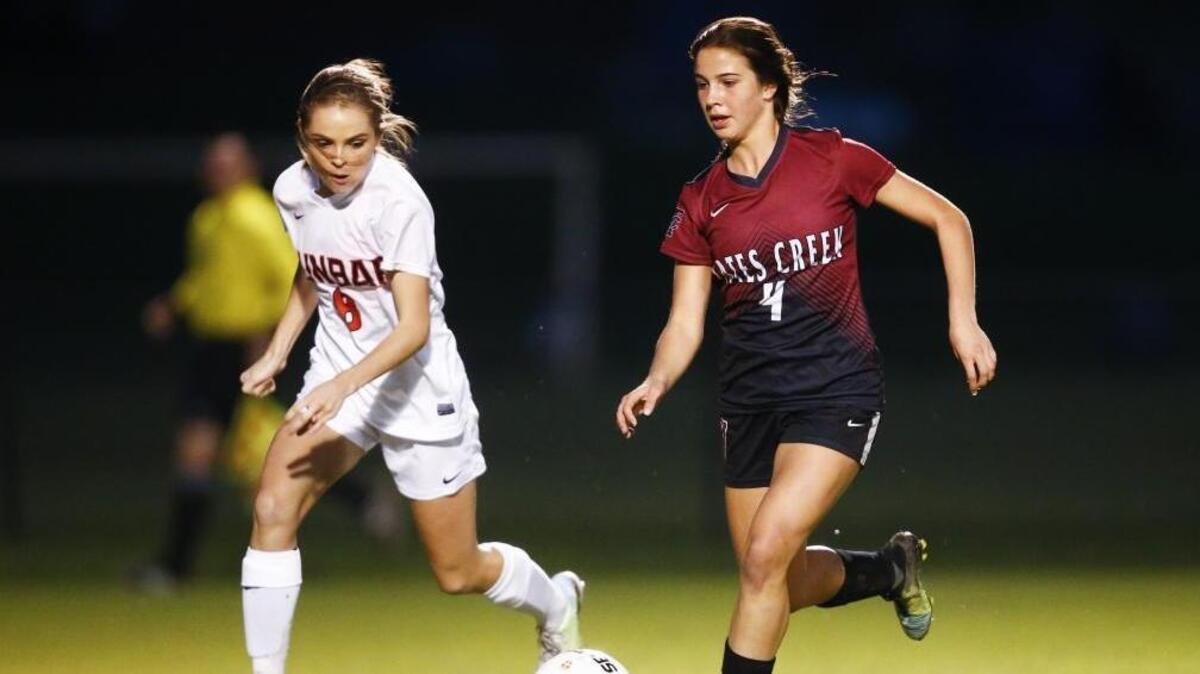 Tates Creek's Shae Robertson (4) keeps the ball away from Paul Laurence Dunbar's Sophia Mitchell (8) during their 43rd District semifinal soccer game at Lexington Christian Academy in Lexington, Ky., Wednesday, Oct. 11, 2017. Tates Creek beat Paul Laurence Dunbar 3-2 on Penalty Kicks.
