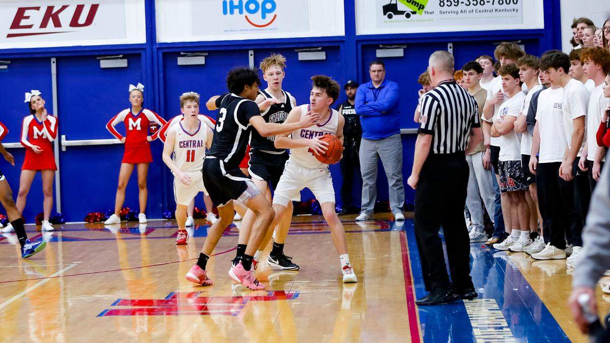 Frederick Douglass’ DeMarcus Surratt (3) and Tate Robinson surrounded Madison Central’s Will Richardson in the fourth quarter of the Broncos’ 62-52 win in the boys 11th Region Tournament quarterfinals at Madison Central High School in Richmond on Tuesday.