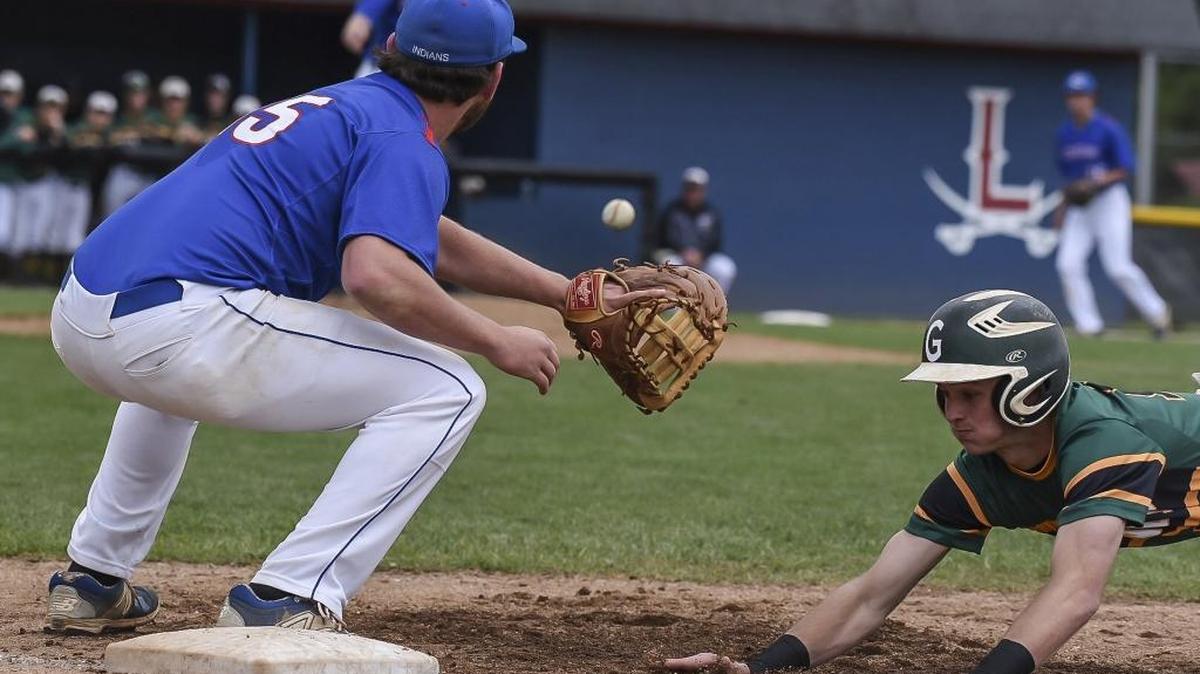 Greenup County’s Gage Hughes (13) avoids a tagged from Madison Central’s first base Jared Grant (15) in the first inning at Lafayette High School during the Fayette County Invitational Tournament in Lexington on Saturday, May 14, 2016.