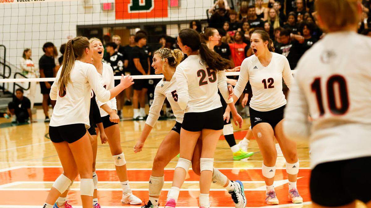 Paul Laurence Dunbar’s volleyball team, including, from left, Mia Pendley, Peyton Beatty, Mya McDowell, Isabela Haggard, Julia Wright and Makenzie Lowe, celebrate winning a point in their match at Frederick Douglass High School on Thursday.