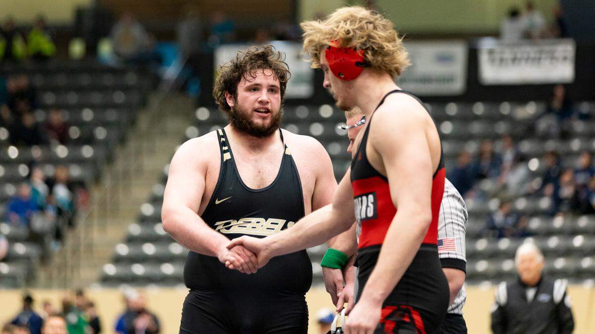Boyle County’s Paul McClure shakes hands with Pleasure Ridge Park’s Tucker Roth after McClure’s stunning pin to overcome a 7-3 deficit with 27 seconds left in the 285 class finals Saturday.