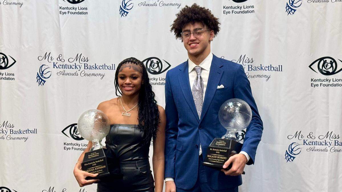 Sacred Heart’s ZaKiyah Johnson, left, and Great Crossing’s Malachi Moreno pose with their respective Miss and Mr. Basketball trophies after receiving the awards from the Kentucky Lions Eye Foundation and Kentucky Association of Basketball Coaches at the Marriott Griffin Gate Resort on Sunday.