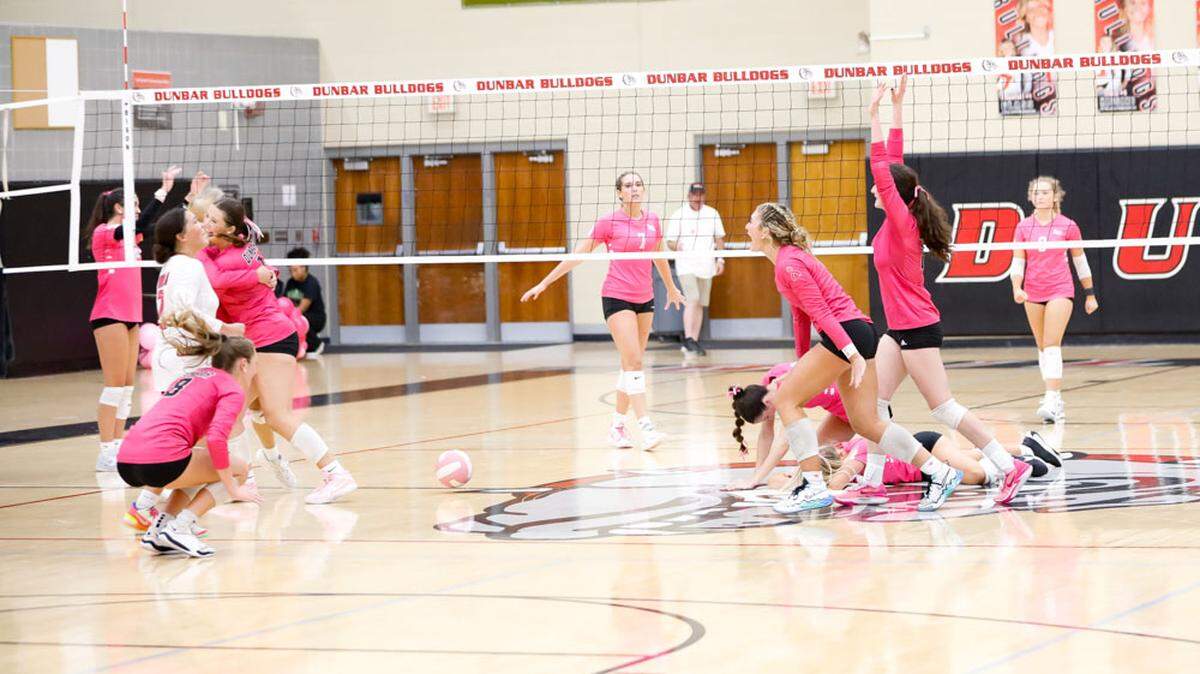 Paul Laurence Dunbar, near court, celebrates closing out a five-set victory over 43rd District rival Lexington Catholic in a battle of top 25 teams at Paul Laurence Dunbar High School on Tuesday.