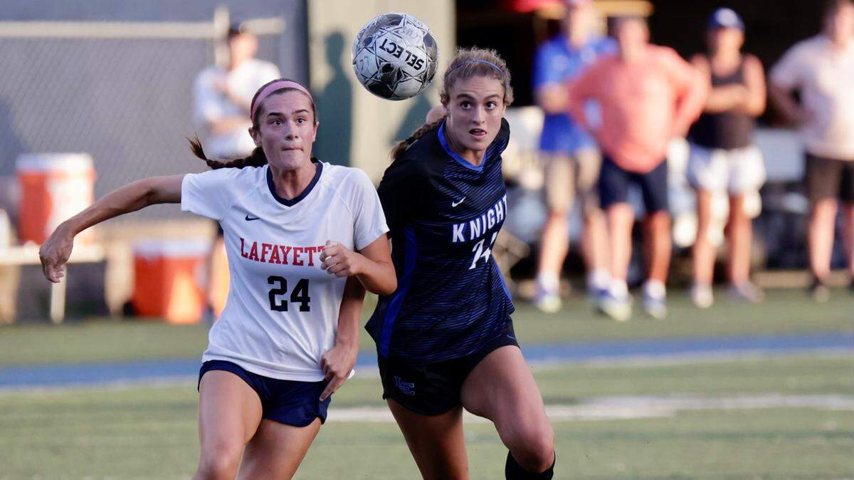 Lafayette’s Piper Smith, left, and Lexington Catholic’s Zara McCarthy track down a ball during the Knights’ 2-0 win at LexCath’s Joseph K. Ford Stadium on Monday, the only regular season meeting this year between the 43rd District rivals.