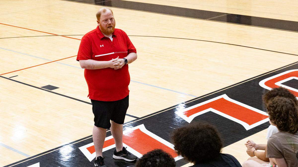 New Paul Laurence Dunbar High School boys basketball coach Steve Quattrocchi introduces himself to players and family members at the school’s S.T. Roach Sports Center on Saturday after the announcement of his hiring a day earlier.