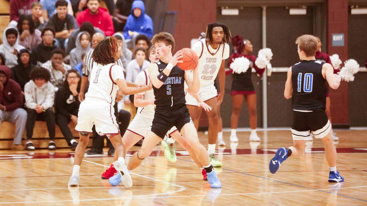 Lexington Christian’s Andrew Maggard (5) looks for options as he’s surrounded by Tates Creek’s A.J. Slaughter (1) and Brady Manning with teammate Saxton Howard (10) occupying the attention of Tates Creek’s Latrell Jones-Miller (23) during their game at Tates Creek High School on Tuesday.