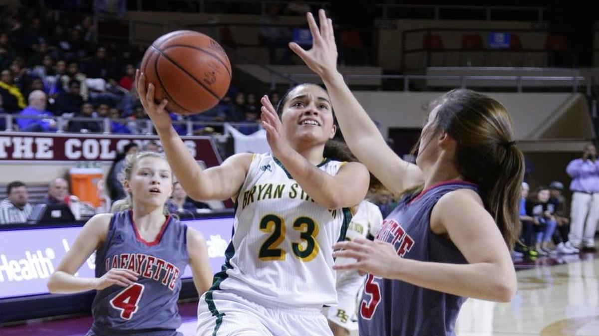 Bryan Station's J'lyn Martin, scored over Lafayette's Caroline Bennett for some of her 13 first half points as Bryan Station played Lafayette in the 11th region tournament semi finals on Friday March 4, 2016 in Richmond, Ky.
