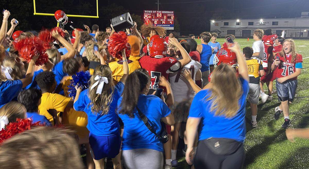 Lafayette’s student section rushes the field to join its football team in celebrating the Generals’ 25-12 win over Moore at the school’s Ishmael Stadium, which ended the team’s 19-game losing streak on Friday.
