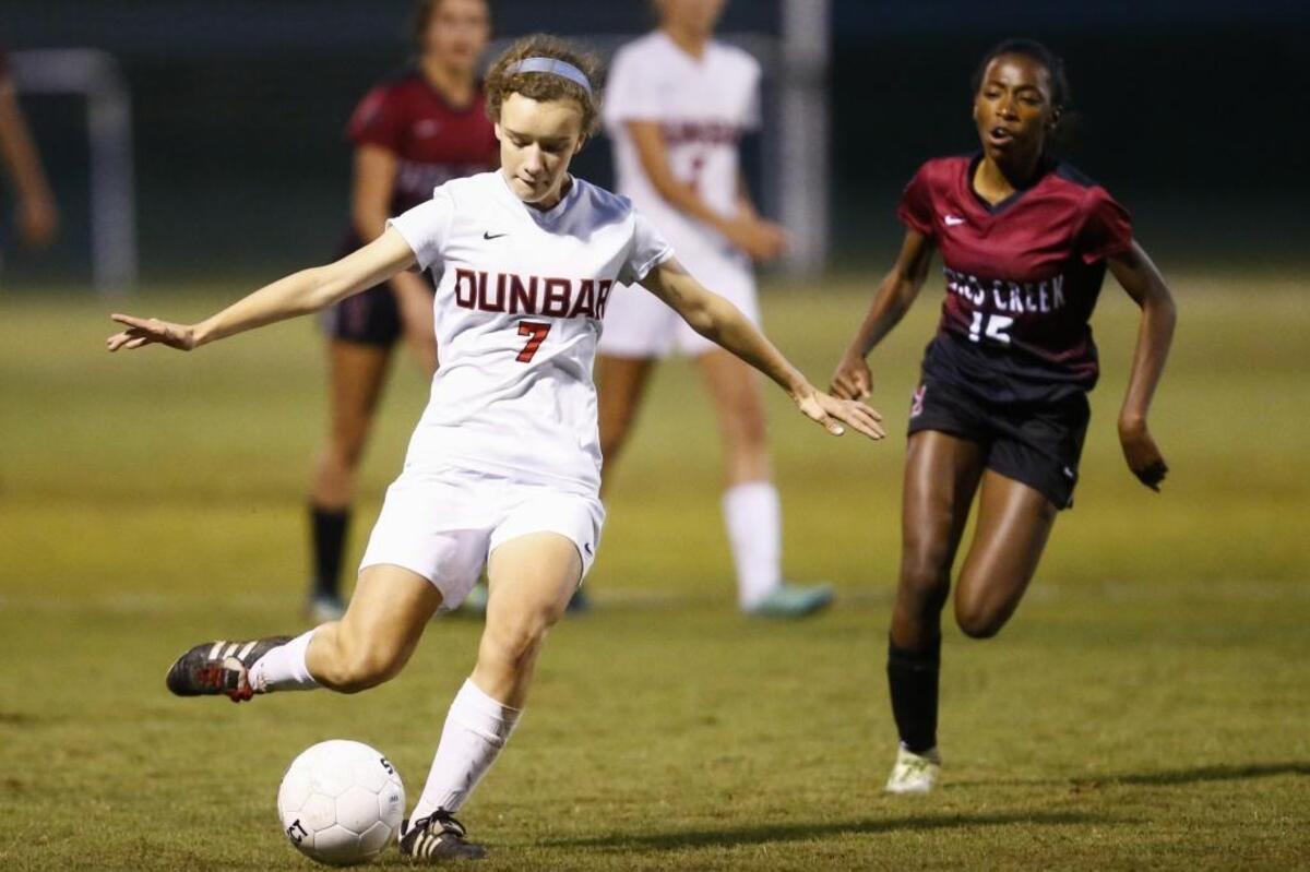 Paul Laurence Dunbar's Molly Mohr (7) kicks the ball past Tates Creek's Alex Smith (15) during their 43rd District semifinal soccer game at Lexington Christian Academy in Lexington, Ky., Wednesday, Oct. 11, 2017. Tates Creek beat Paul Laurence Dunbar 3-2 on Penalty Kicks.