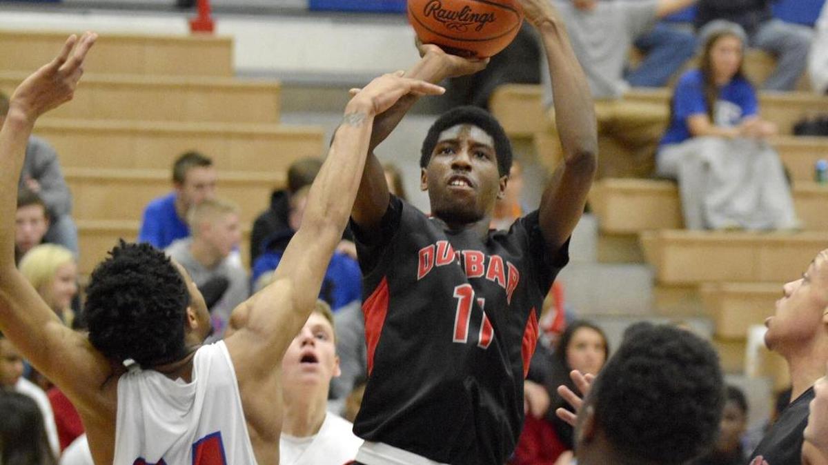 Dunbar's Taveion Hollingsworth shoots over Madison Central's Cameron Thomas, Tuesday night, January 6, 2015, in Richmond. Central won 66-63. Photo by Tim Webb