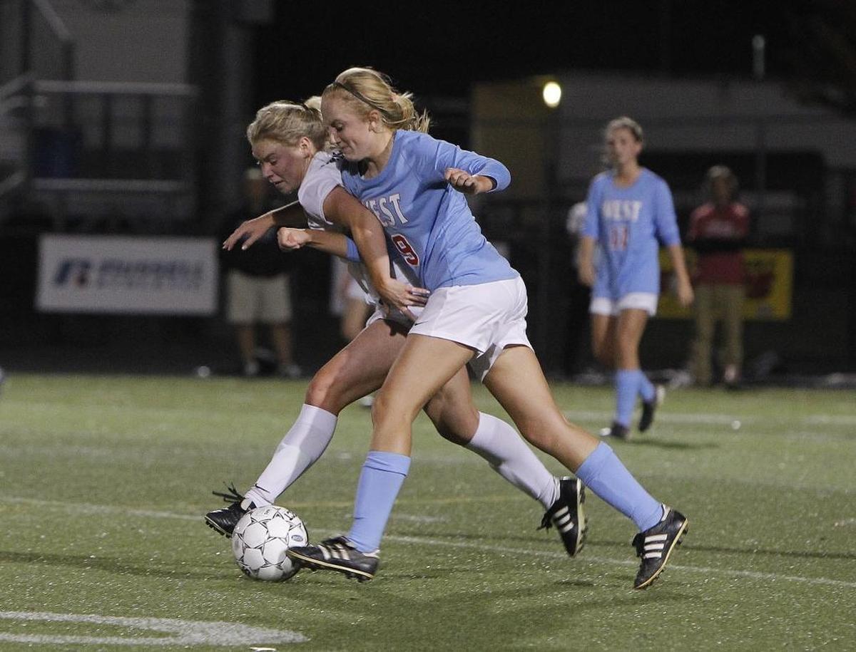 West Jessamine's Hailey Cole battles against Sacred Heart's Lexie Wagner during the semifinals of the KHSAA girls' state soccer championship at Ishmael Stadium in Lexington, Ky., Thursday, November 2, 2017.