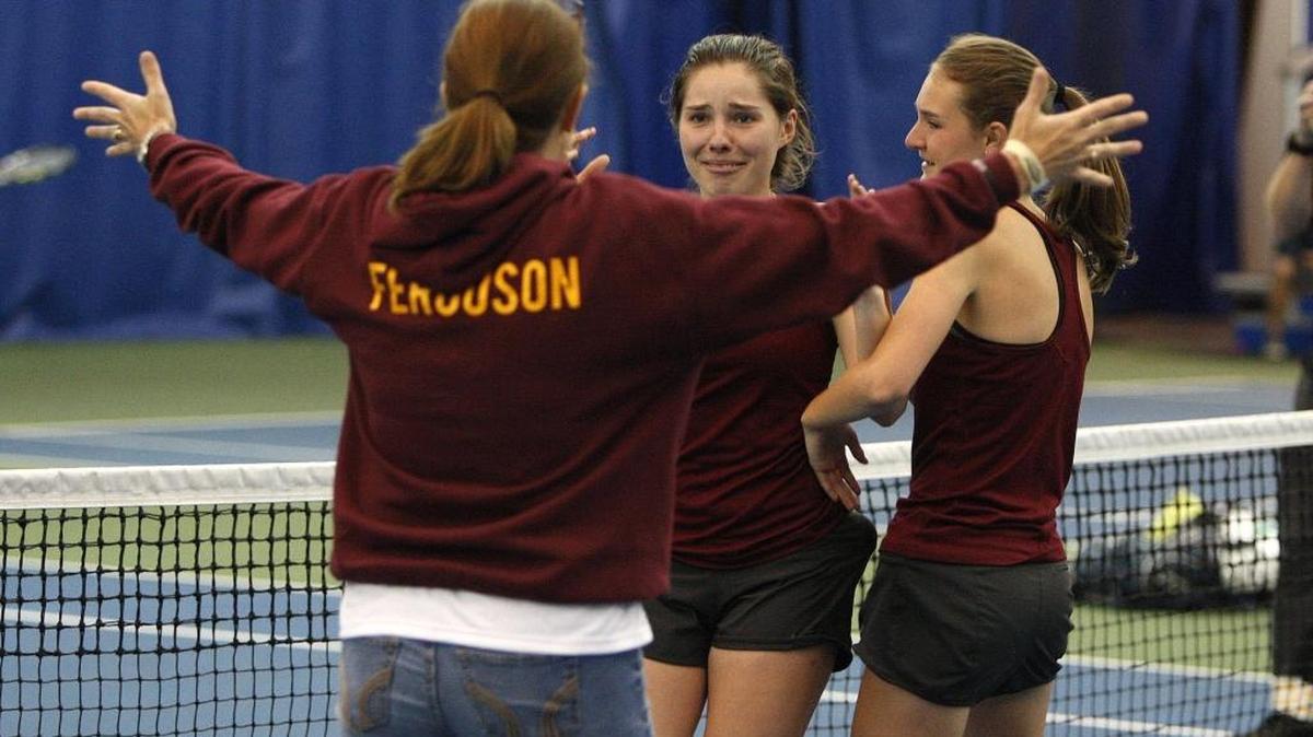 Russell tennis coach Lara Ferguson opens her arms to embrace Kierstin Hensley after Hensley and Lara's daughter Maci Ferguson won the girls' doubles title at the KHSAA state tennis championship at Boone-Downing Tennis Complex in Lexington, Ky., Saturday, May 21, 2016.