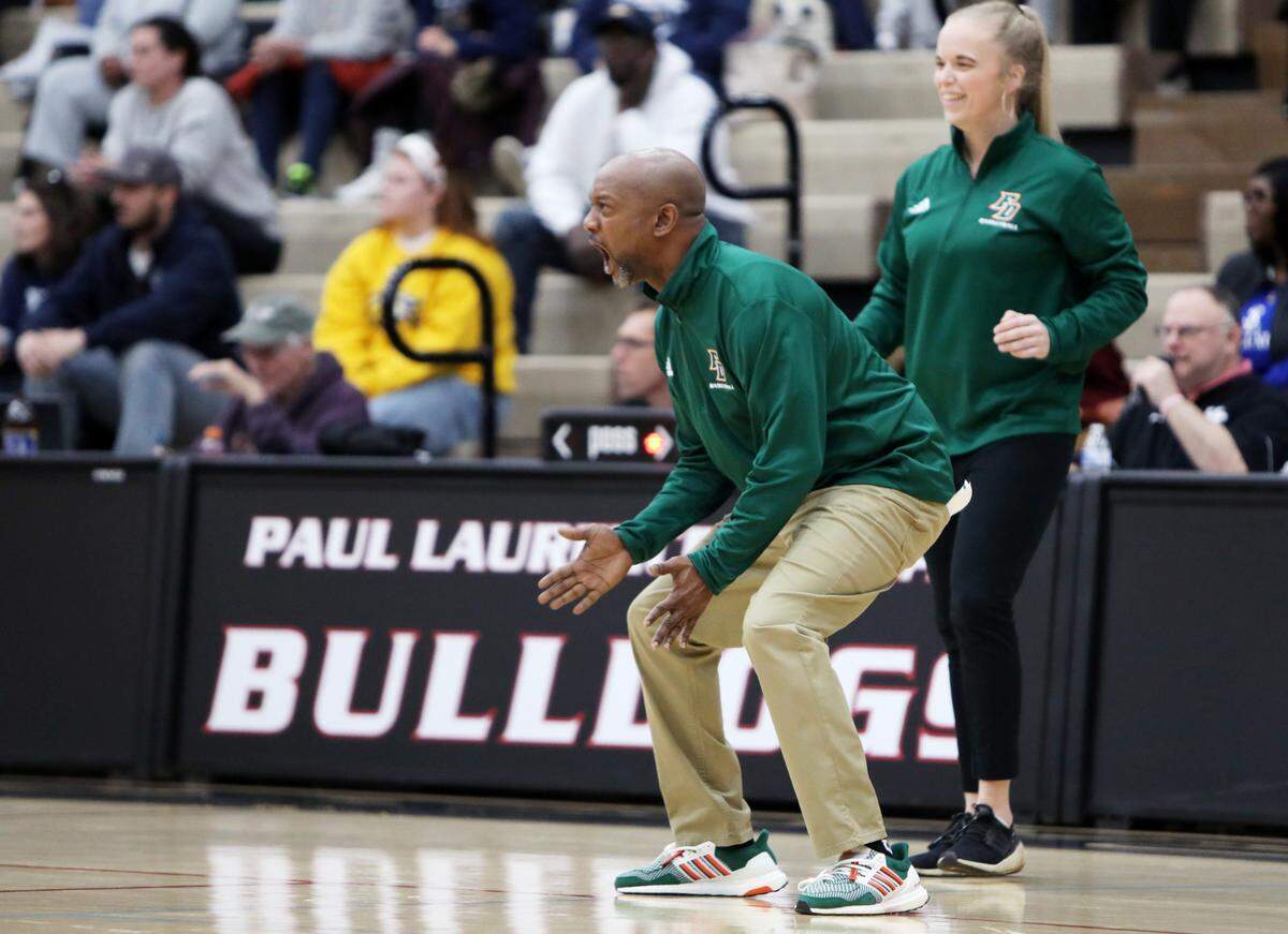 Frederick Douglass Coach Daryl Moberly celebrates the Broncos’ win over Franklin County in the girls 11th Region Tournament semifinals at Paul Laurence Dunbar High School’s S.T. Roach Sports Center on Thursday.