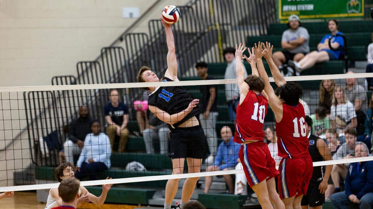 Henry Clay’s McAllister “Mac” Millar goes for a kill over Lafayette’s Paxton Lehman and Jaiden Vanover during the Blue Devils’ 3-0 win in the 7th Region boys volleyball tournament finals at Bryan Station High School on Monday.