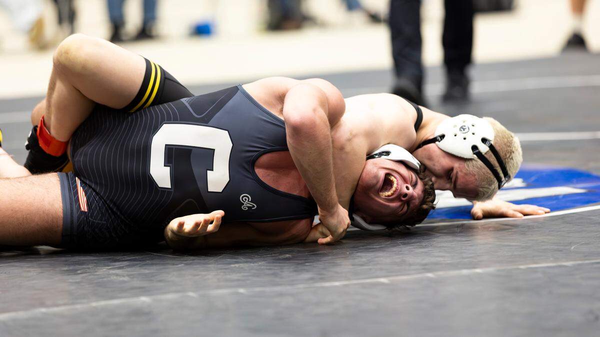 Woodford County’s Isaac Johns, at back, had to release a hold on Johnson Central’s Ryan Smith during Johns’ win in the 150 class finals Saturday.