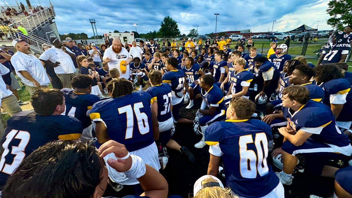 Franklin County head coach Eddie James, standing with his yellow hat in his hand, delivered a postgame talk with the Flyers after their win over Lexington Christian last season in the Rebel Bowl. The Flyers host LCA Friday.