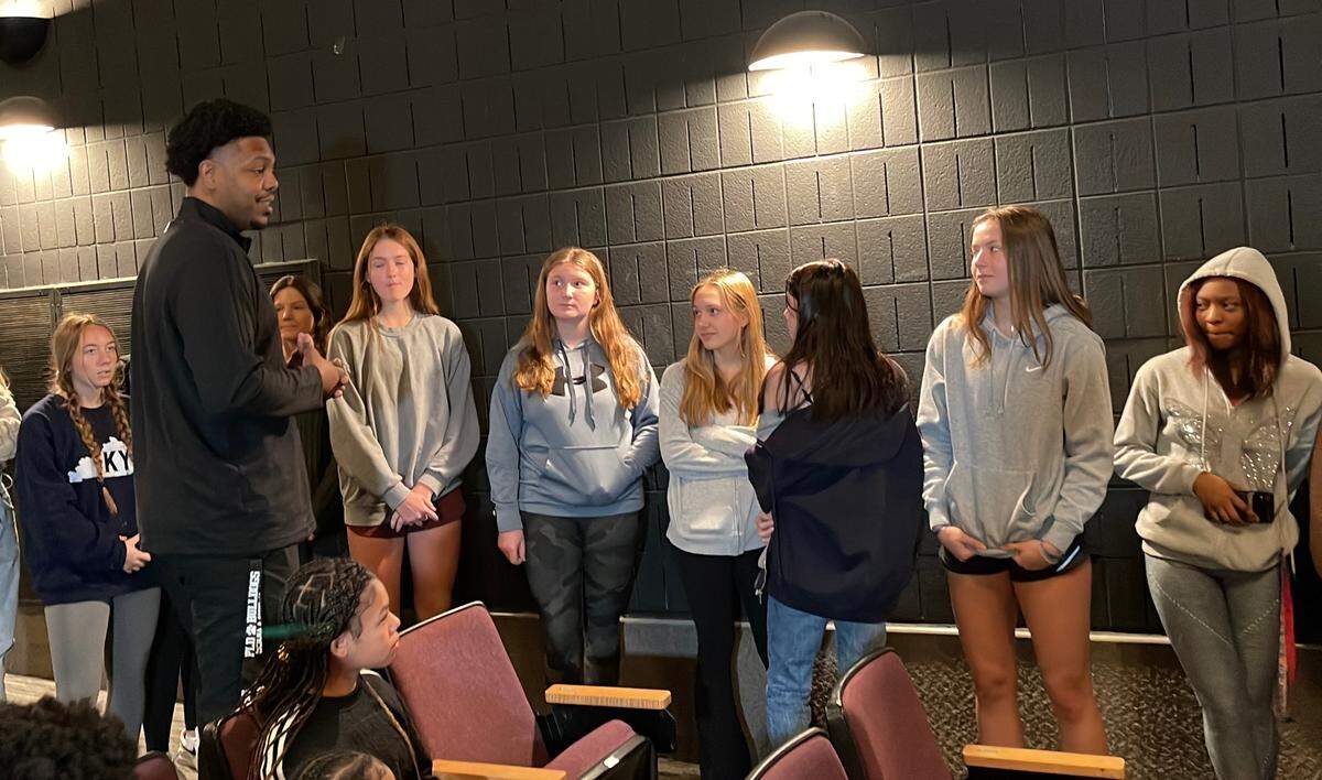 Erik Daniels, left, the new head coach of Paul Laurence Dunbar High School’s varsity girls’ basketball team, speaks with some of the players after he was introduced at the school on Thursday. Daniels left Woodford County to take the Dunbar position.