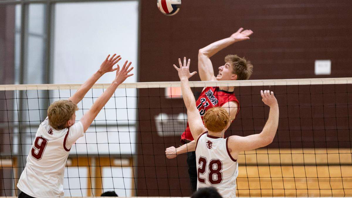 Paul Laurence Dunbar’s William Naehr (23) leaps for a kill against the defense of Tates Creek’s Cosmo Reynolds (9) and Zane Hinkle (28) at Tates Creek High School on Thursday.