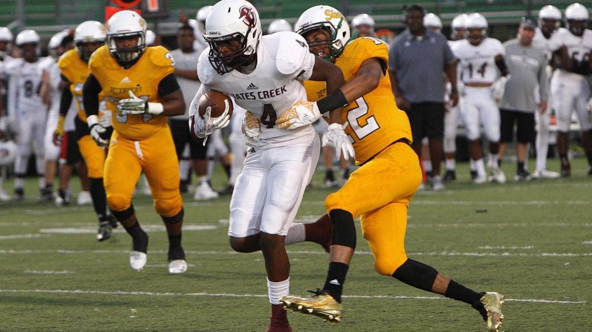 Tates Creek's Elijah Johnson runs against Bryan Station's Jacob Kenney at R. L. Grider Stadium, Ky., Friday, September 23, 2016.