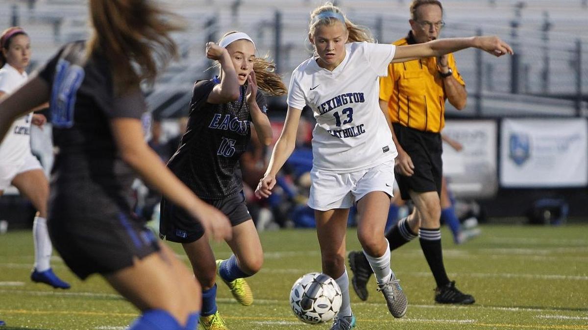 Lexington Catholic's Maggie Corbett dribbled against LCA's Grace Jacobs, left, in the 43rd District semifinal.