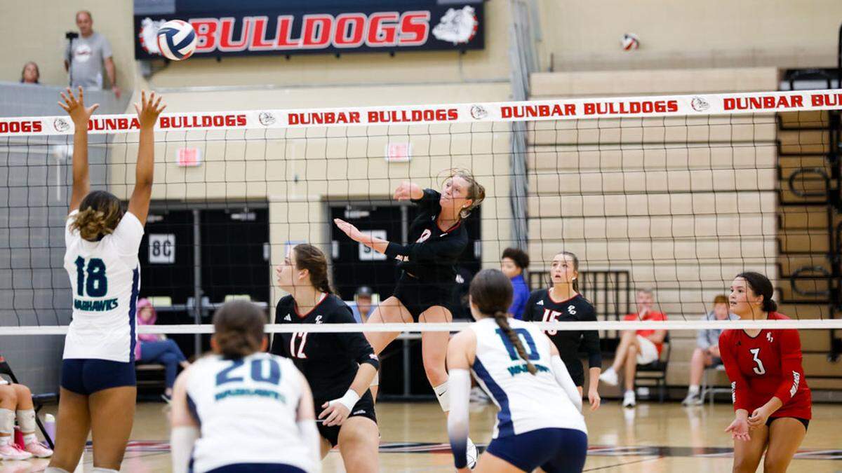 Paul Laurence Dunbar’s Mia Claire Barnes (8) follows through on the kill that ended the Bulldogs’ five-set match against Great Crossing on Thursday.