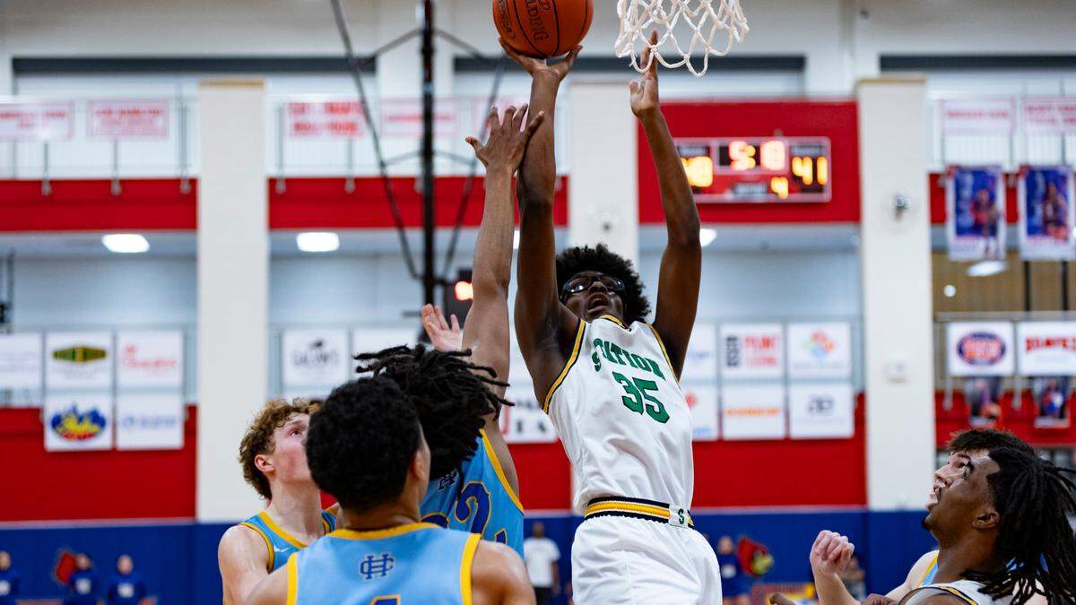 Bryan Station’s Taeshawn Adams (35) goes up for a shot amid three Henry Clay players during the Defenders’ 60-48 win in the 42nd District Tournament semifinals at Scott County High School’s Billy Hicks Gymnasium in Georgetown on Wednesday.