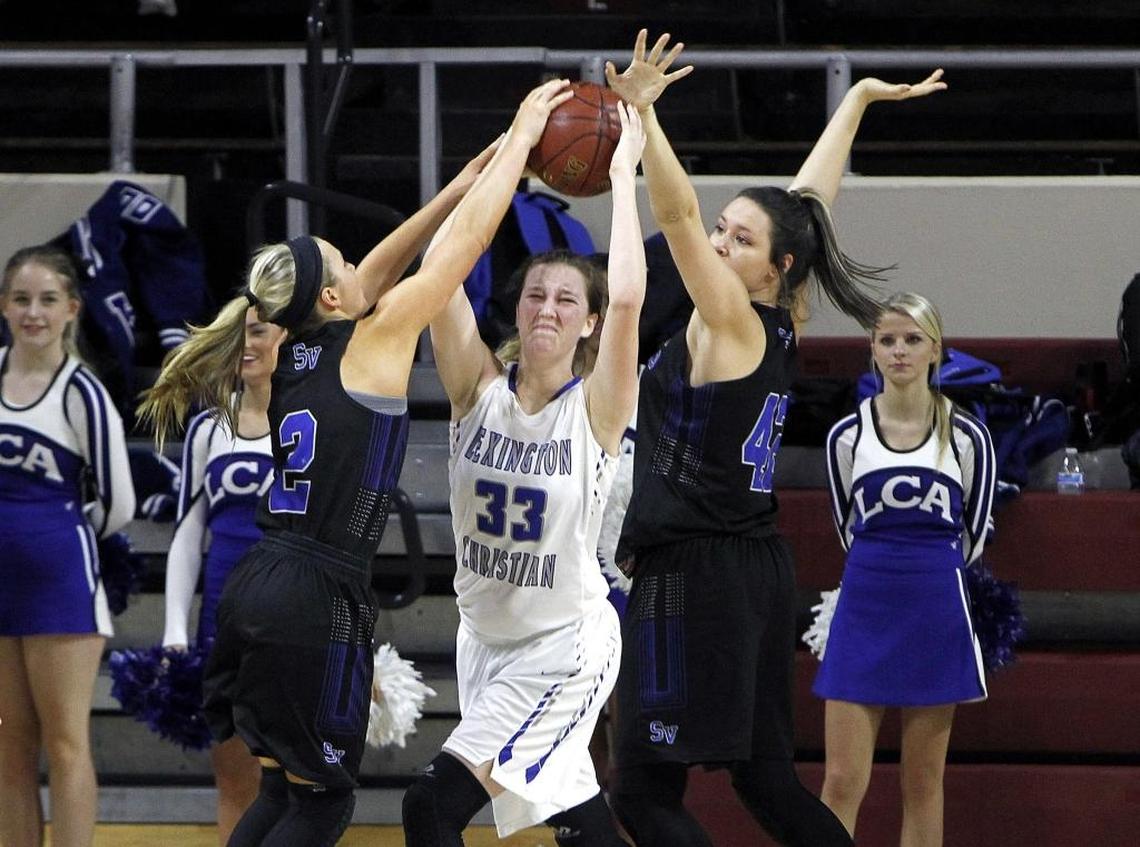 Shelby Valley's Cassidy Rowe, left, and Alyssa Elswick tie up Lexington Christian's Emilie Teall in the All 'A' Classic at Alumni Coliseum in Richmond, Ky., Wednesday, January 24, 2018.