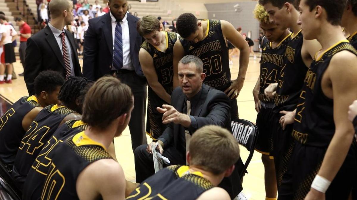 Woodford Co. head coach Ryan Wilson talks with his team between quarters while playing Dunbar in the S. T. Roach Gymnasium in Lexington, Ky., Monday, November 28, 2016.