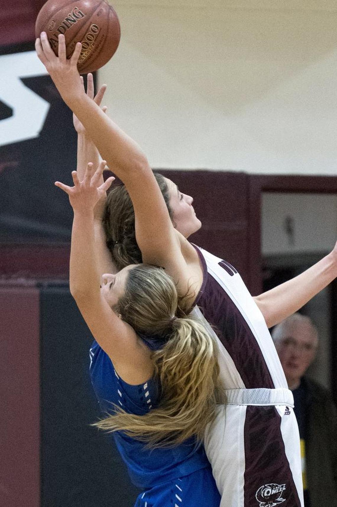 Owsley County senior Macie Gibson, right, brings in one of 20 rebounds against district rival Estill County Tuesday, January 30, 2018, at Owsley County High School in Booneville, Ky. Gibson scored 45 points in the 65-59 overtime win.