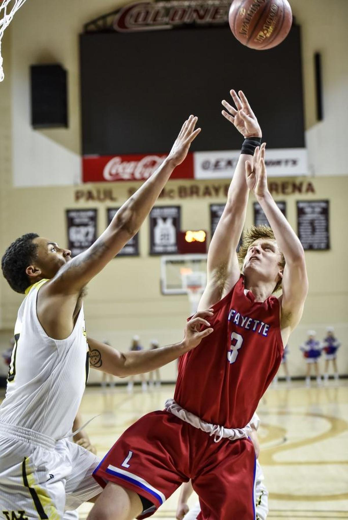 Lafayette's Cameron King (3) shoots over Woodford County's Nicholas Smith (0), during the first round of the 11th Region tournament, Thursday night, March 1, 2018, at EKU's McBrayer Arena in Richmond.