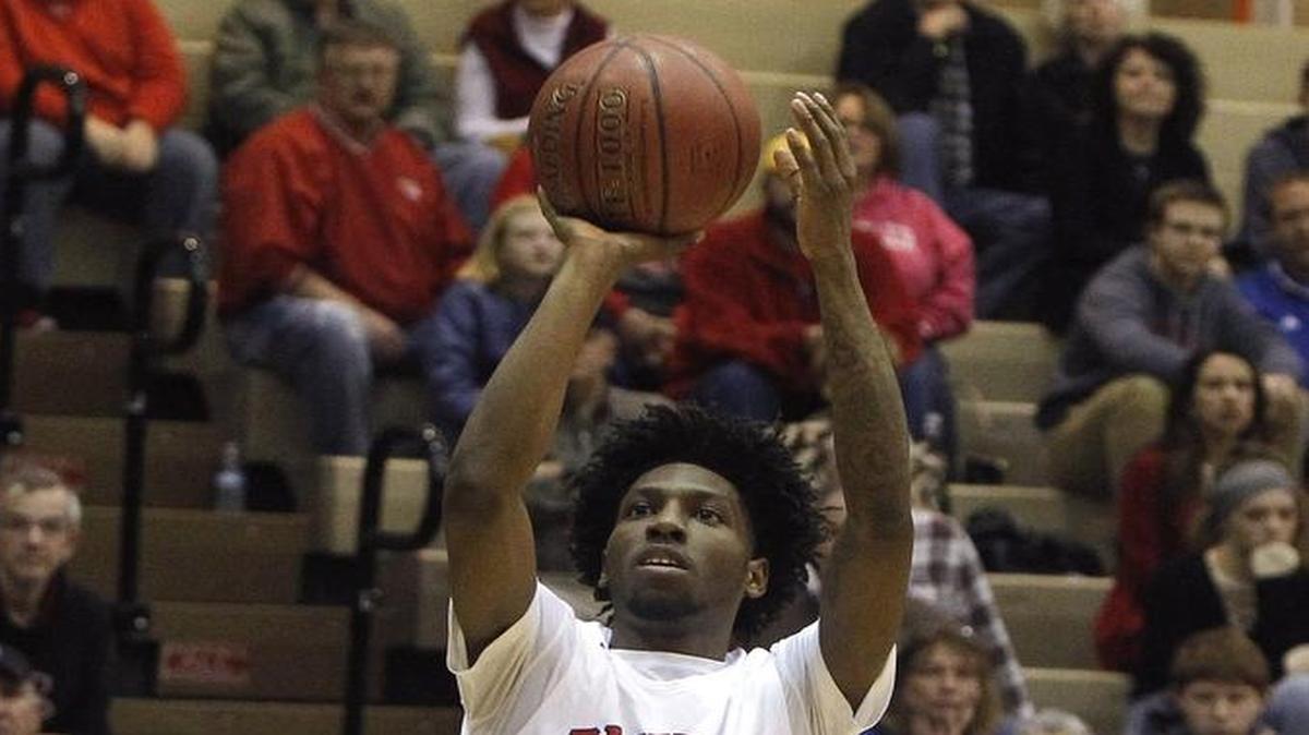 Paul Laurence Dunbar's Taveion Hollingsworth shoots against Scott Co. in the S. T. Roach Gymnasium in Lexington, Ky., Thursday, February 17, 2017.