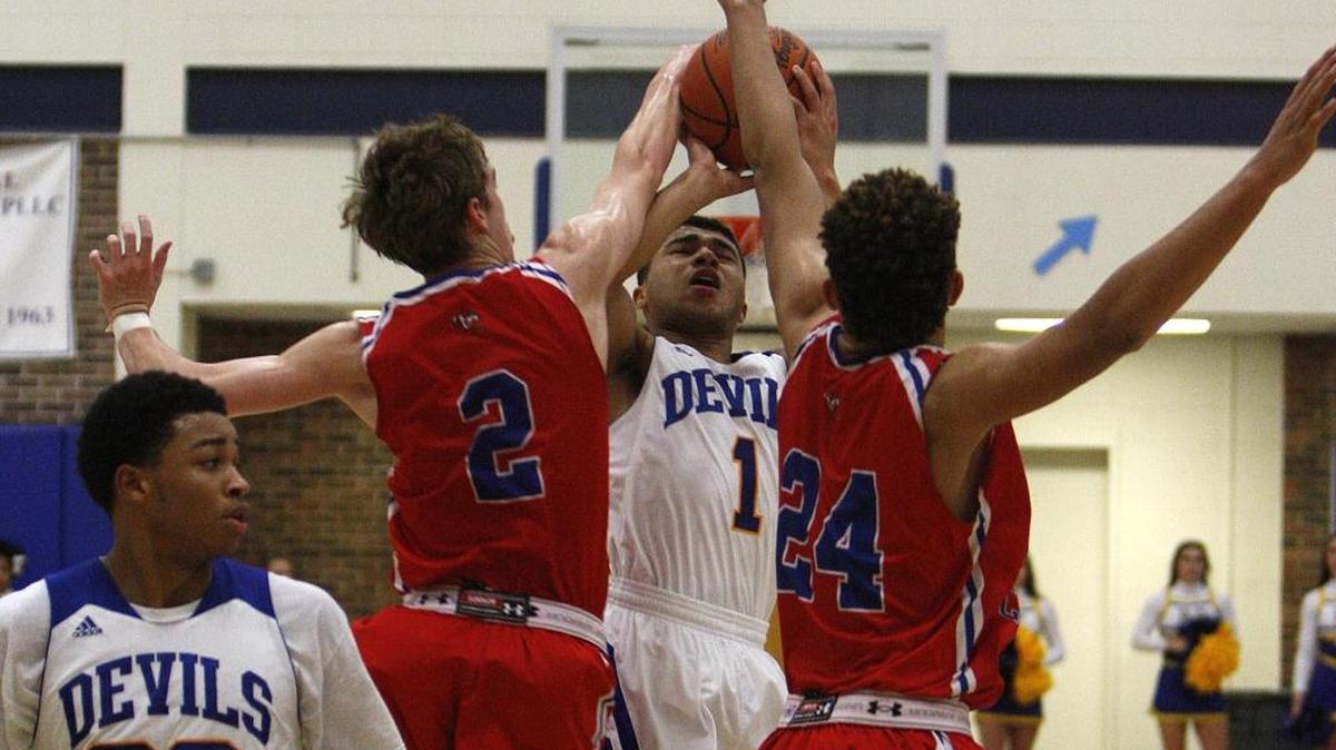 Scott County's Bryce Long, left, blocks the shot by Henry Clay's Paul Price in the Al Prewitt Gymnasium in Lexington, Ky., Friday, January 7, 2016.