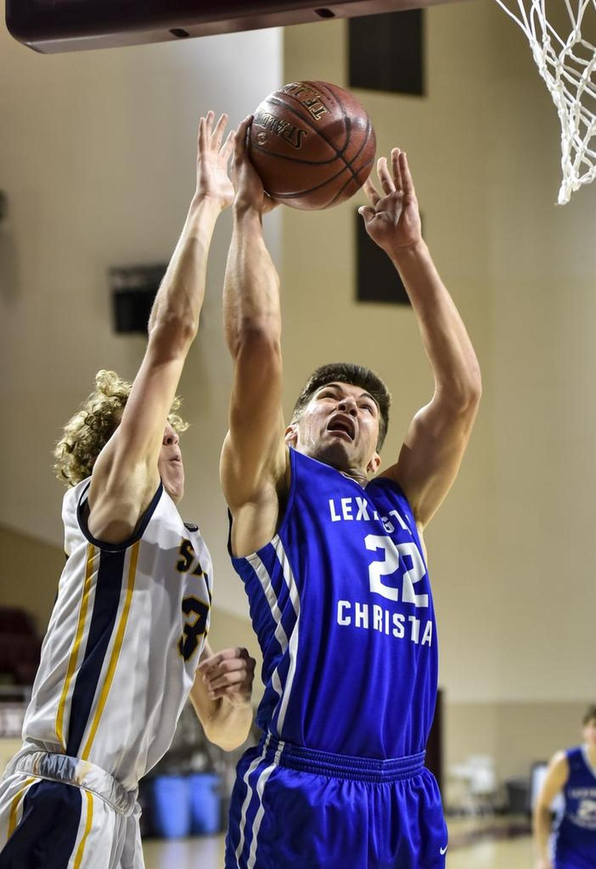 LCA's Kyle Rode (22) shoots two over Sayre's Marcus Bowie (31), during the championship of the boys 11th Region All-A Classic Tournament, Saturday, January 21, 2017, at EKU's McBrayer Arena in Richmond.