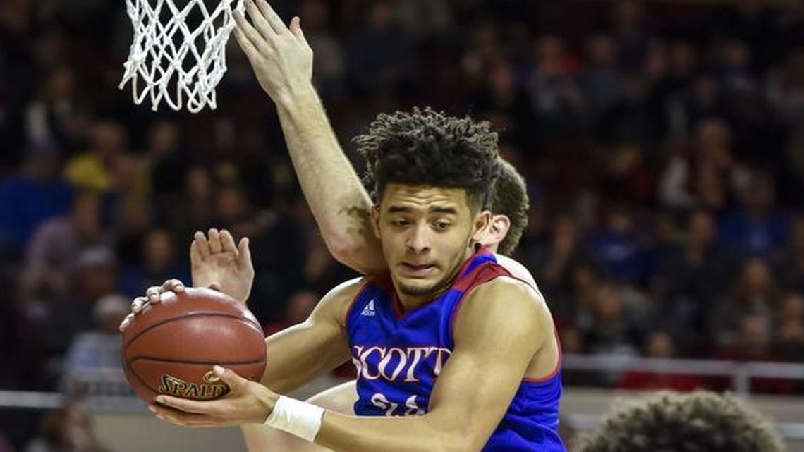 Scott County's Michael Moreno (24) grabs a rebound over Lexington Catholic's Max Sparkman (14), during the boys 11th Region Tournament finals, Monday, March 6, 2017, at EKU's McBrayer Arena in Richmond.