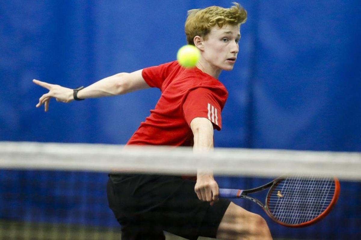 Paul Laurence Dunbar's Matt Halpin returns the ball during his singles match against Henry Clay's Noah Tapp during the 11th Region tennis finals at the University of Kentucky, Thursday, May 11, 2017.