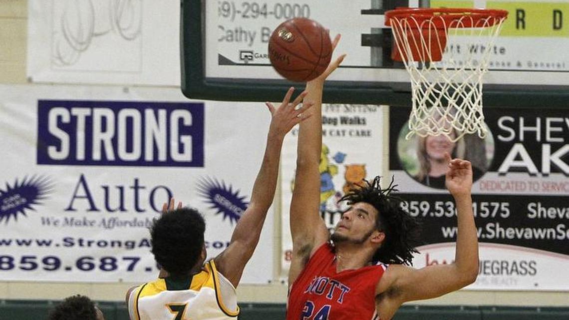 Scott County's Michael Moreno blocks the shot by Bryan Station's Jalen Burbage at Bryan Station gym in Lexington, Ky., Monday, January 22, 2018.