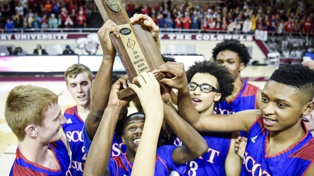 Scott County's Cam Fluker (1), center, holds the championship trophy with his teammates after beating LCA 46-44, during the finals of the boys 11th Region tournament, Monday, March 5, 2018, at EKU's McBrayer Arena in Richmond.
