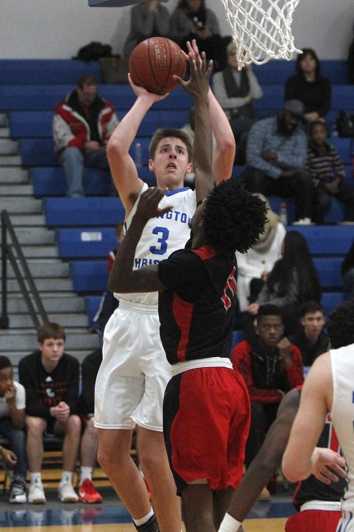 Lexington Christian's Carter Hendrickson shoots against Paul Laurence Dunbar's Taveion Hollingsworth at Lexington Christian Academy in Lexington, Ky., Friday, January 6, 2017.