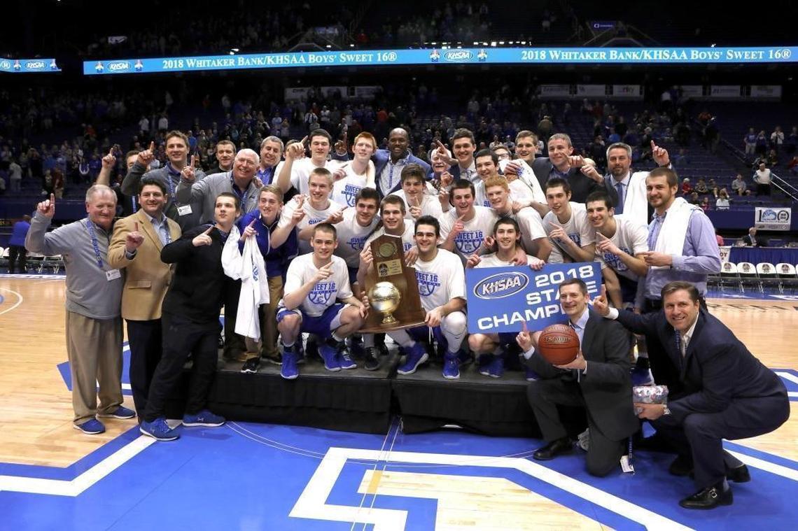 Covington Catholic players with the trophy after winning the championship game of the 2018 Whitaker Bank KHSAA Sweet 16 basketball tournament at Rupp Arena.