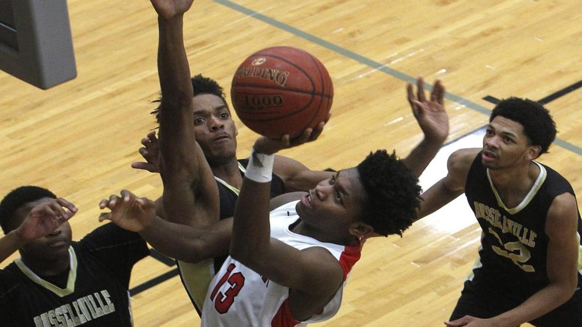 Paul Laurence Dunbar's Star Ifeacho shoots with pressure from Russellville's Jaylyn Murray during the boys' Traditional Bank Holiday Classic in the Beuter Gymnasium at Lexington Catholic in Lexington, Ky., Tuesday, Dec. 27, 2016.