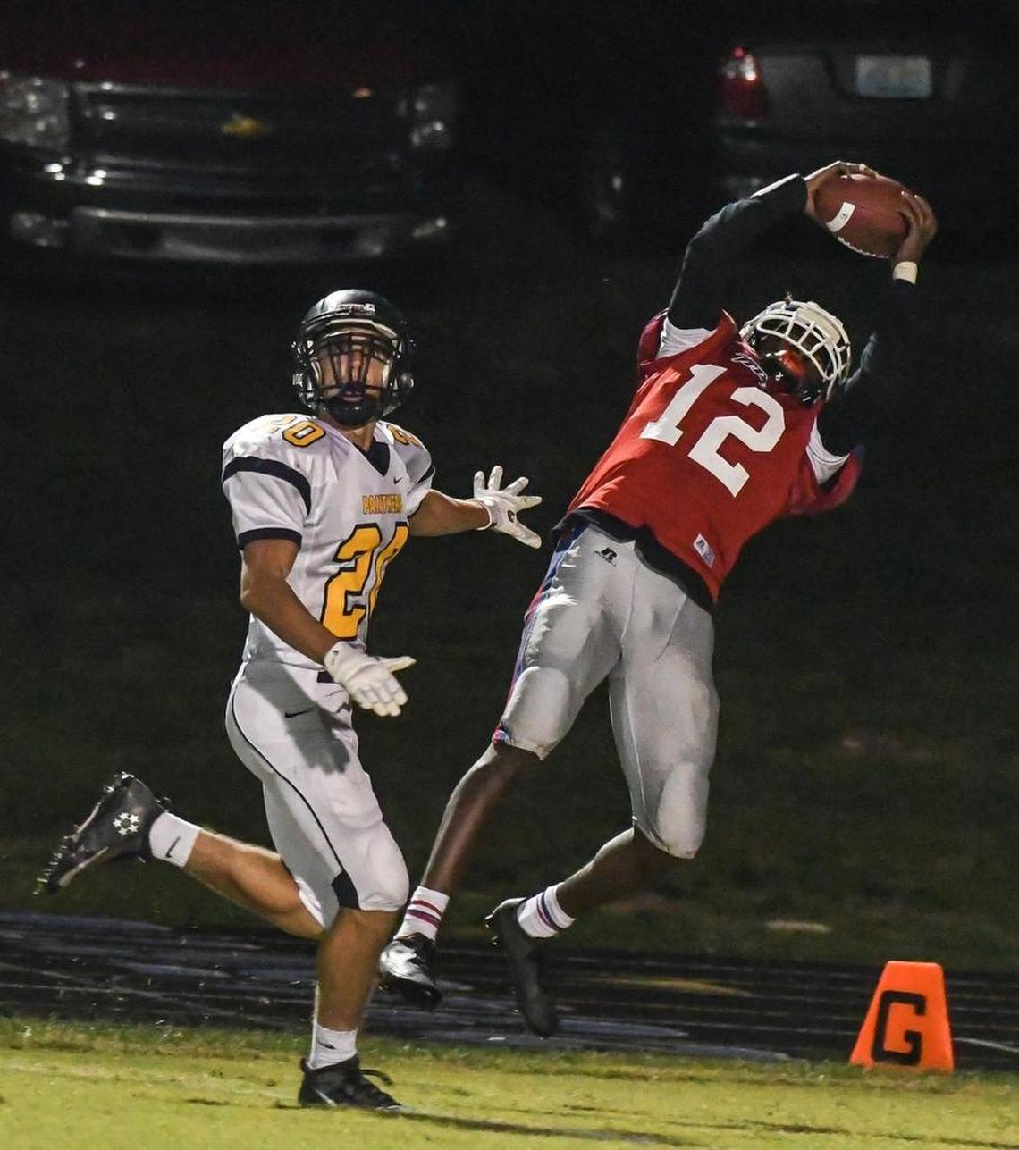 Mercer County High School's Trevon Faulkner (12) catches a touchdown past Knox Central's Dane Imel (20) in the second quarter during the first-round Class 4A game Friday, November 4, 2016., at Mercer County High School in Harrodsburg, KY. Knox Central Dane Imel (20)