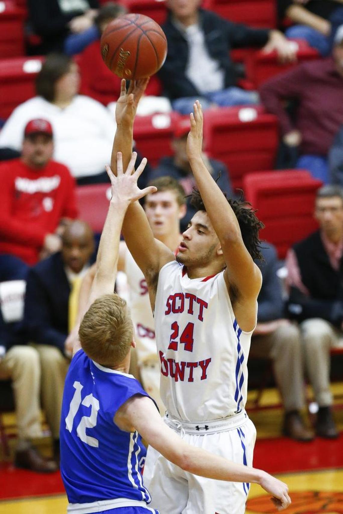 Scott County's Michael Moreno (24) shoots past Lexington Christian's Will Hacker (12) during their game at Scott County High School in Georgetown, Ky., Thursday, Dec. 7, 2017. Scott County beat Lexington Christian 68-59.