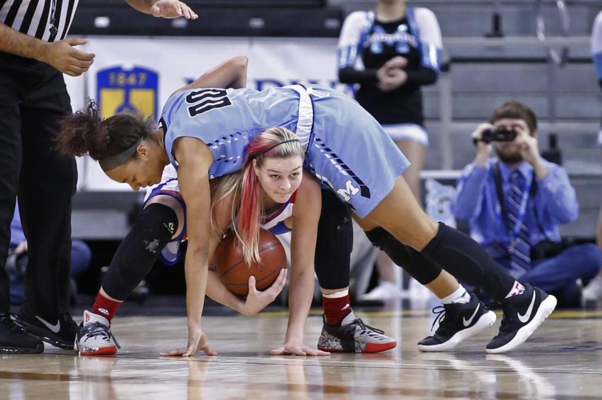 Mercy’s Jaylyn Shorter, top, fell over Mercer County’s Emma Davis during Sunday’s state championship game at Northern Kentucky University.