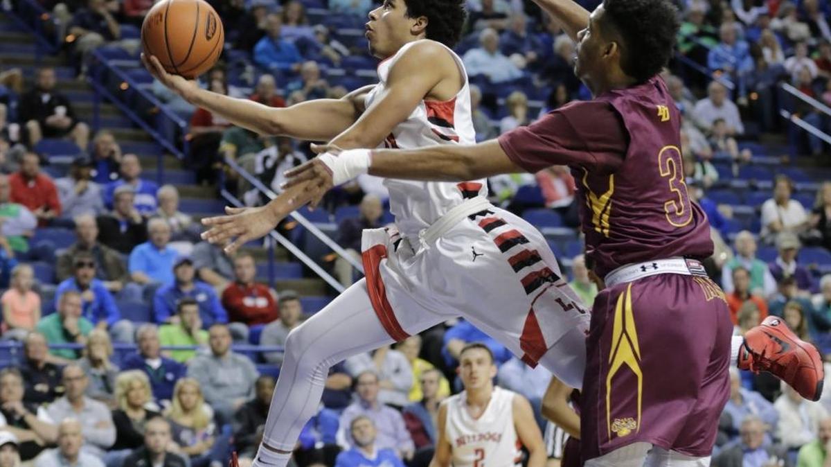 Lawrence County’s Timmy Dalton (10) was defended by Doss’ Laron Hargrove during the state tournament in Rupp Arena last March.